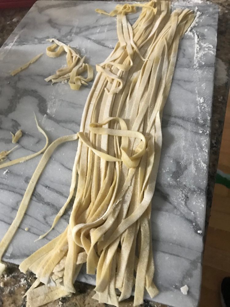 raw pasta on a marble cutting board 