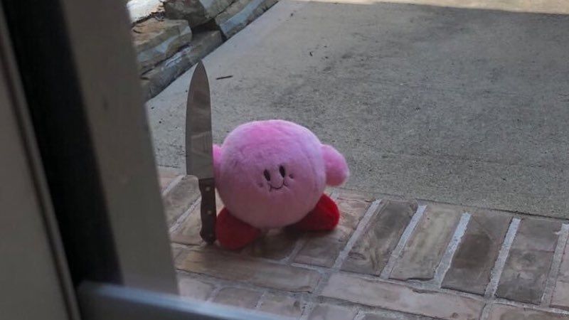 Meme of a cute pink plush Kirby holding a knife and smiling menacingly.