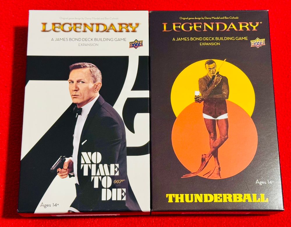 Legendary A James Bond Deck Building Game Expansions boxes No Time To Die and Thunderball next to each other.