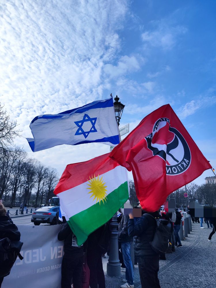 Anti-Hamas-Protest mit israelischer Fahne, kurdischer Fahne und Antifa-Fahne.