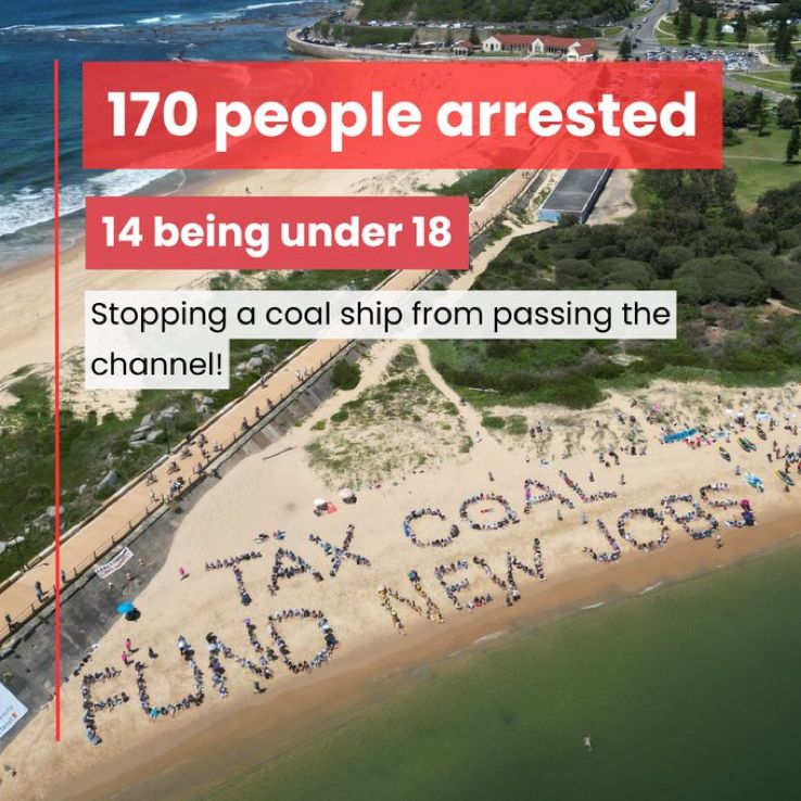 Aerial shot of a beach where people have formed the words TAX COAL FUND NEW jobs 
Caption:170 people arrested
14 being under 18 years 
Stopping a coal ship from getting into the port