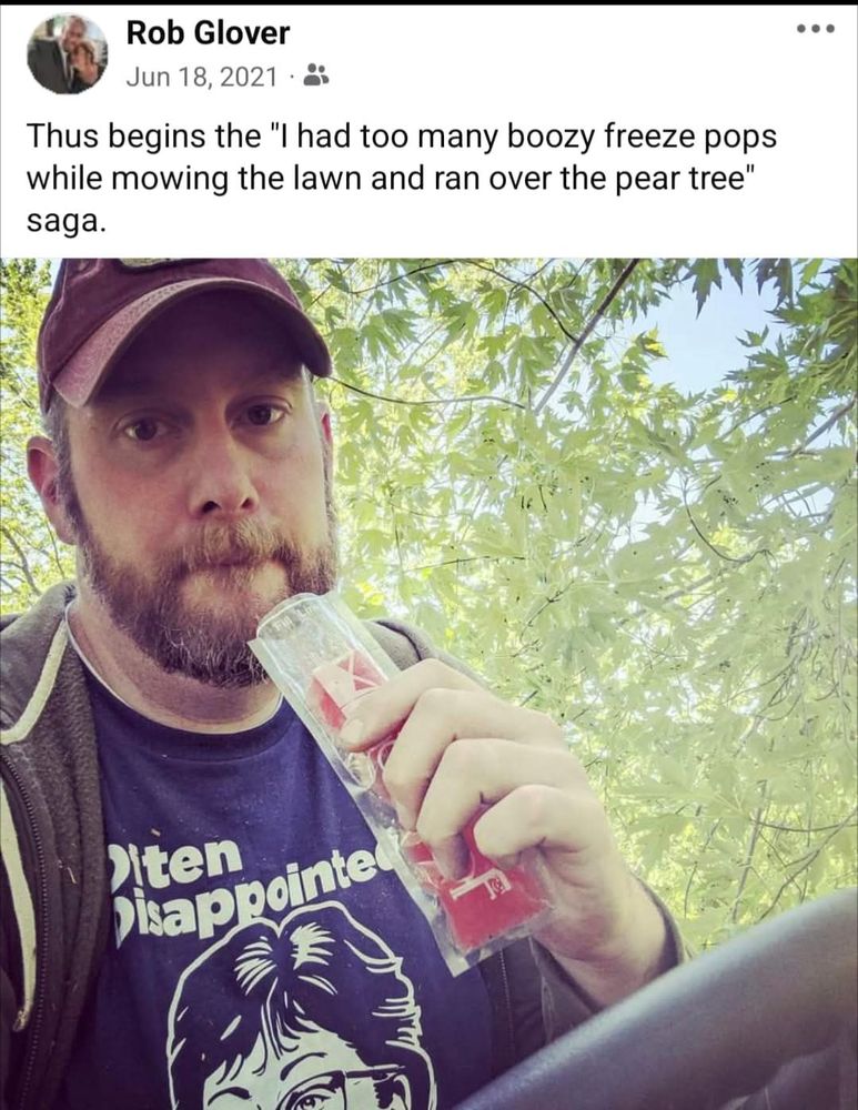 Picture of a man in a blue T-shirt sitting on a riding lawnmower enjoying an alcoholic popsicle. With caption "Thus begins the 'I had too many boozy freeze pops while mowing the lawn and ran over the pear tree' saga."