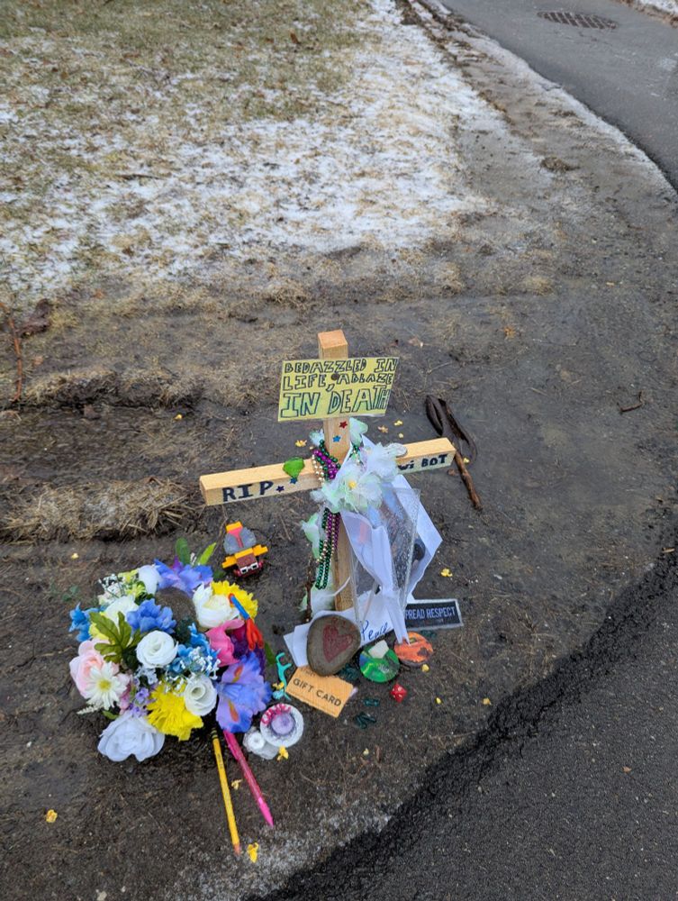 A memorial for a food delivery robot that got crushed by a dump truck and caught fire at the University of Maine. 