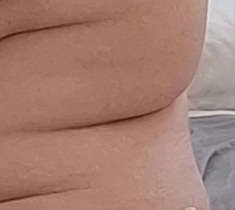 A closeup on folds of flesh creating like a snake of curves 