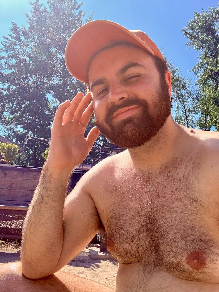 Me sat at a lake smiling. Wearing an orange and not much else!
