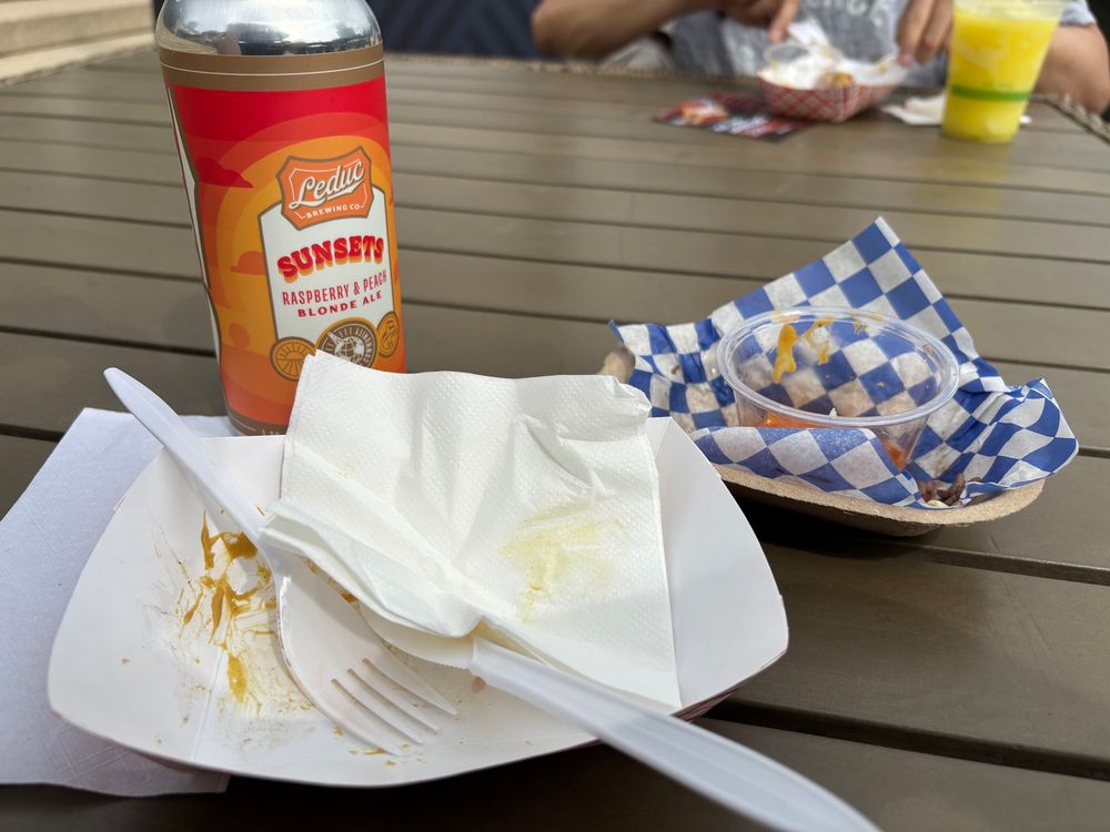 Empty food bowls and a Leduc Brewing beer.
