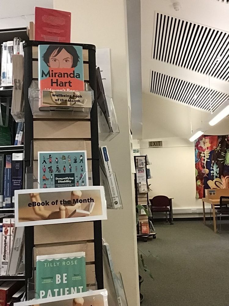 Photo of a Book spinner in the Newcomb Library - featuring our books of the month and new books to the library - pick up a shiny new book here!
On display - Miranda Hart's book, book cover image of Demystifying disability, and Be Patient - see above thread for more details about these books.  In the background is the library study area.
