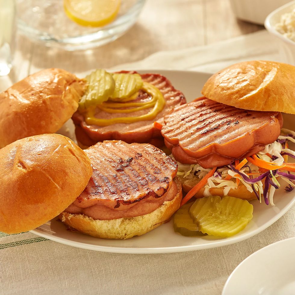 Large round hot dogs on hamburger buns.