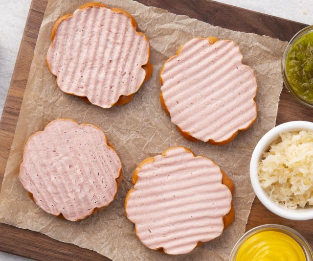 Large round hot dogs that can be served on a hamburger bun.