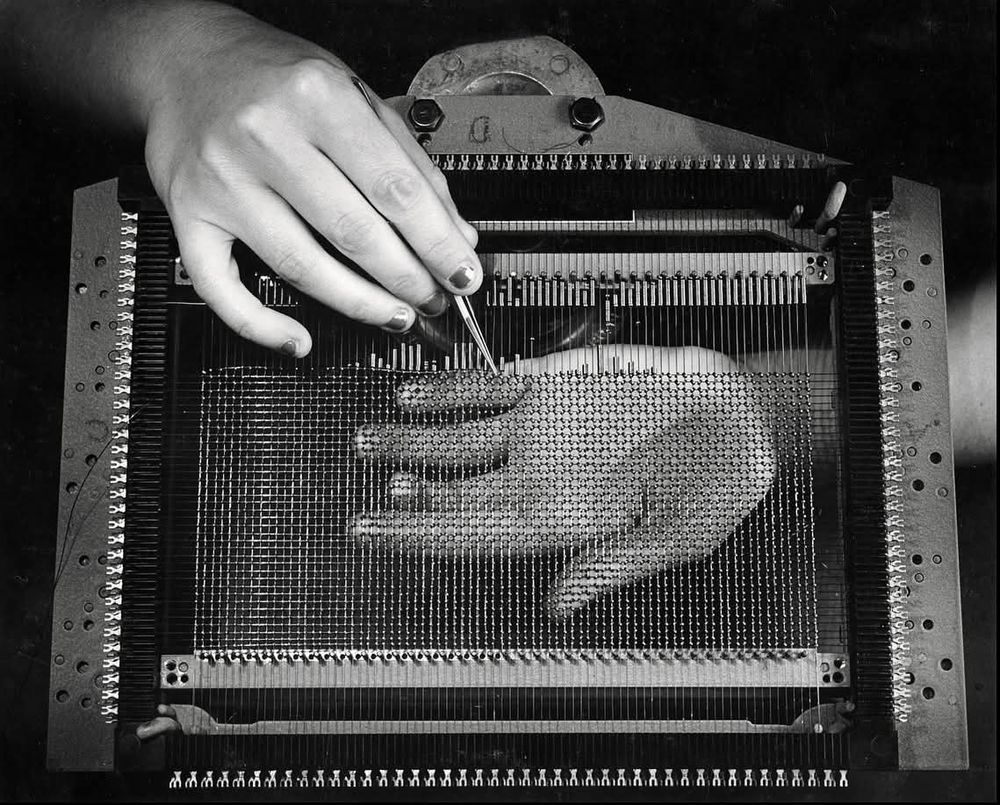 The photograph "Hands weaving magnetic-core memory, IBM, Poughkeepsie, New York" taken by Ansel Adams in 1956.