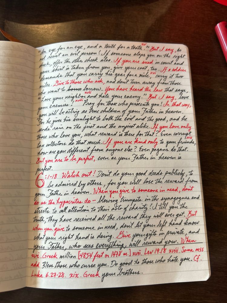 Notebook with handwritten portions of Matthew 5–6 NLT. 
