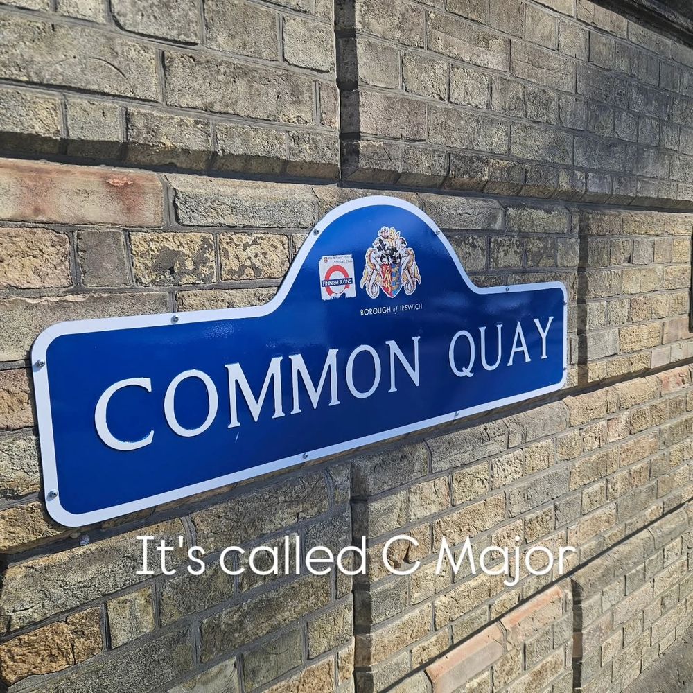 Phoyo of road sign reading "common quay" with a caption added reading "it's called C Major"