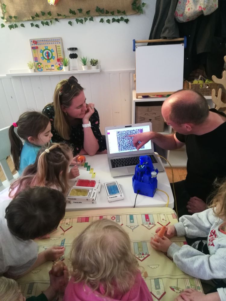 Gerrit and Margriet showing the OpenFlexure Microscope to a group of nursery children.