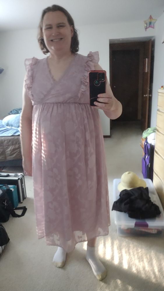 Anya in her bed room mirror selfie wearing pink dress