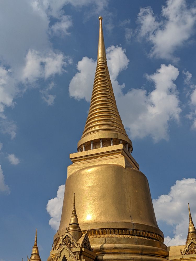 golden temple spire against blue sky