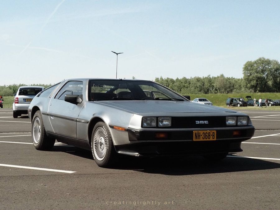 Photo of the DeLorean DMC12 taken by @creatinglightly.art at EMWalhalla. 3/4 front view.