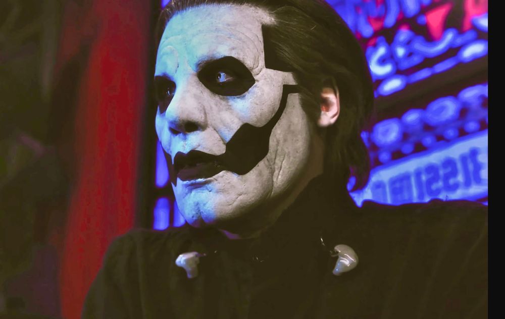 Papa Emeritus IV in Rite Here Rite Now (2024) Miasma backstage conversation with Papa Nihil. He has a somber look on his face after being told that nothing lasts forever. 