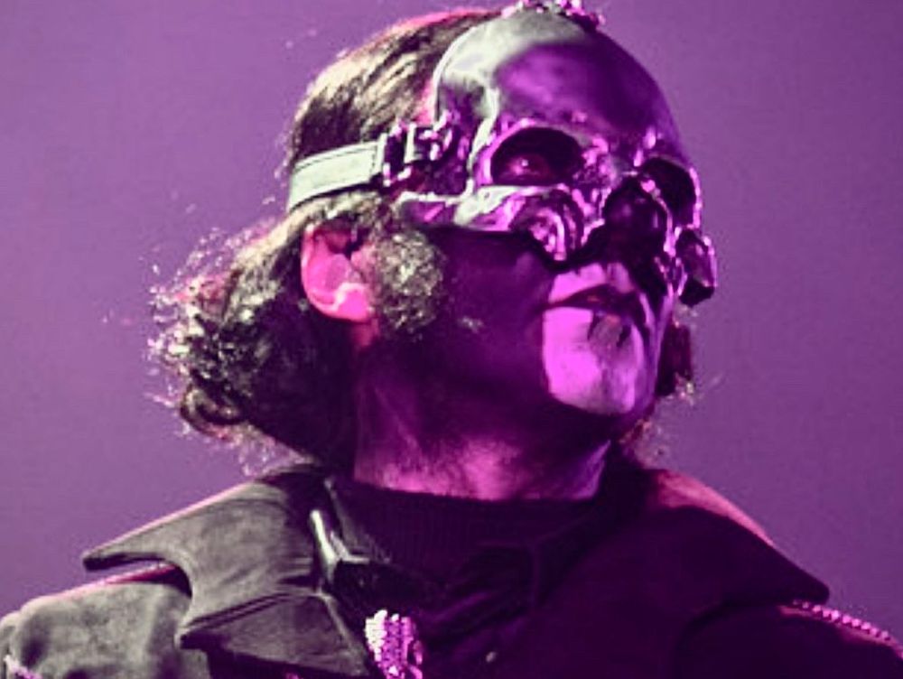 Papa V Perpetua with the same faraway look on his face, illuminated in purple. Photo by Ryan Chang in Miami, Florida 7/13/25