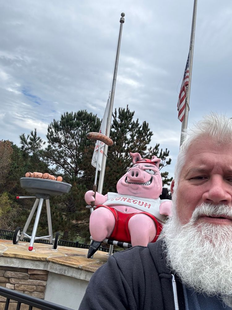 Me in front of a pig eating its siblings