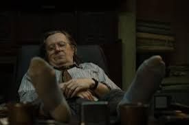 Jackson Lamb napping with his feet propped up on his desk