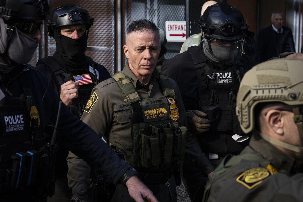 U.S. Border Patrol Commander-at-Large Gregory Bovino in his gear, surrounded by masked up police 