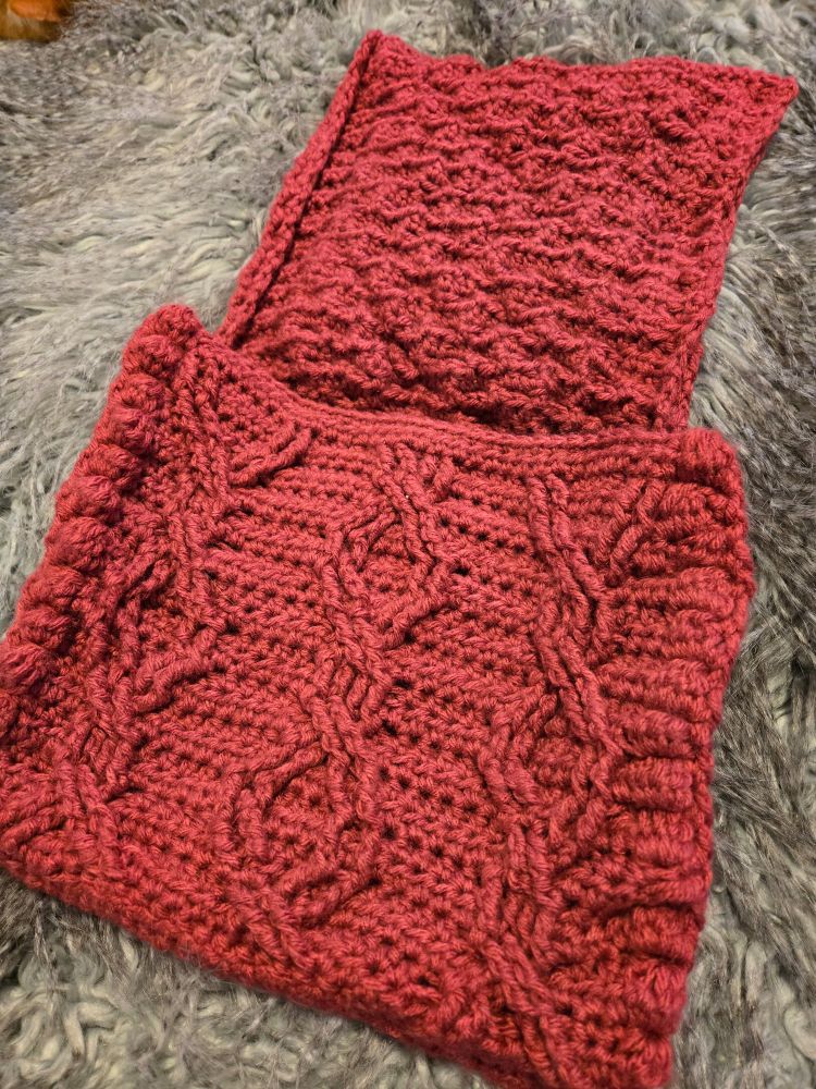 Inside flap of the red cable design crochet bag with complicated woven design  and bobbles.
