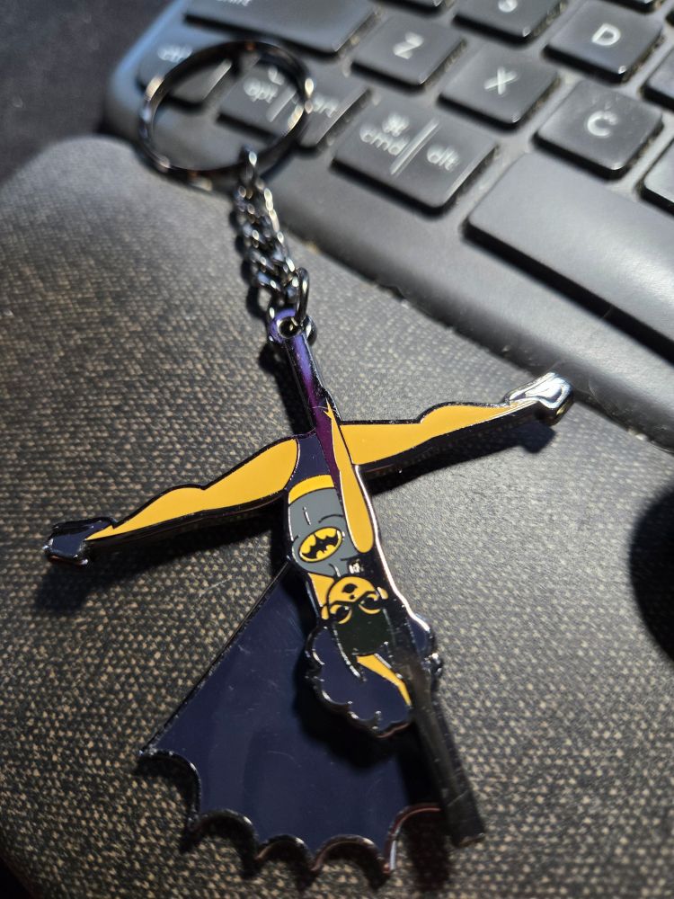 Batgirl poledancer with swinging cape keychain.