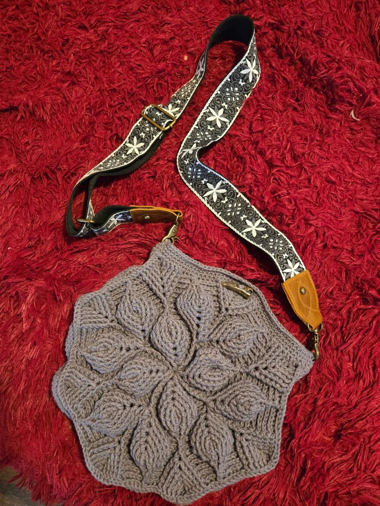 Large grey yarn crocheted 3D leaf bag with grey snowflake shoulder strap.