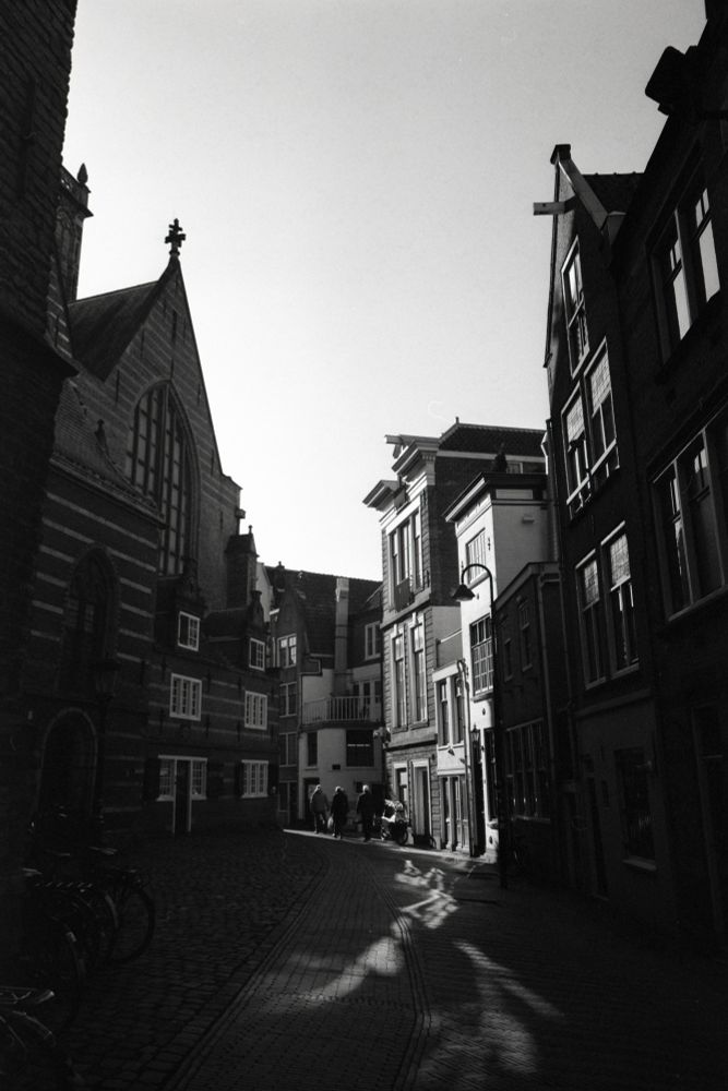 A black and white photo of old Dutch houses behind a church. Shot with a Fuji GSW690ii on Fomapan 400