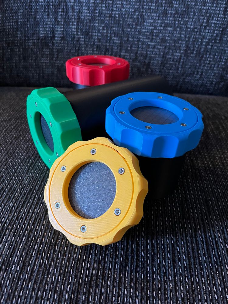 A couple of containers with brightly colored lids, with scalloped grips and a fancy bolt pattern for keeping the parts together