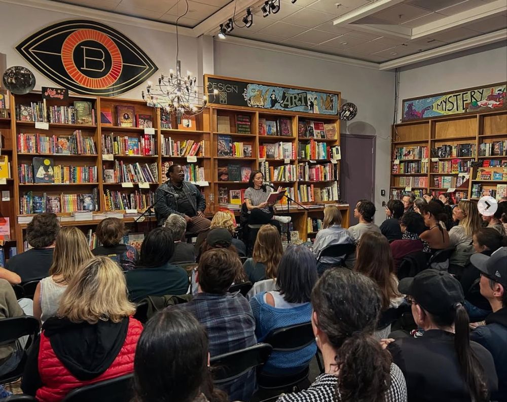 photo of Melissa Febos and Carvell Wallace at the shop last month. It's a full crowd under the big Booksmith eye