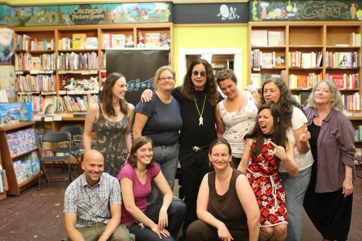 ozzy standing in a huddle with our staff in the old bookstore