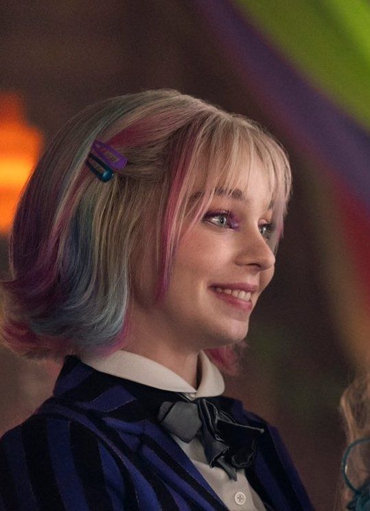 Enid Sinclair from Wednesday, smiling like an absolute cinnamon roll