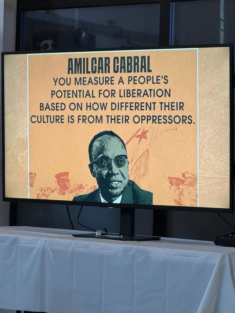 Image shows an illustration of Amilcar Cabral with a faint rendering of a protest in the background. Quote reads: You measure a people’s potential for liberation based on how different their culture is from their oppressors.