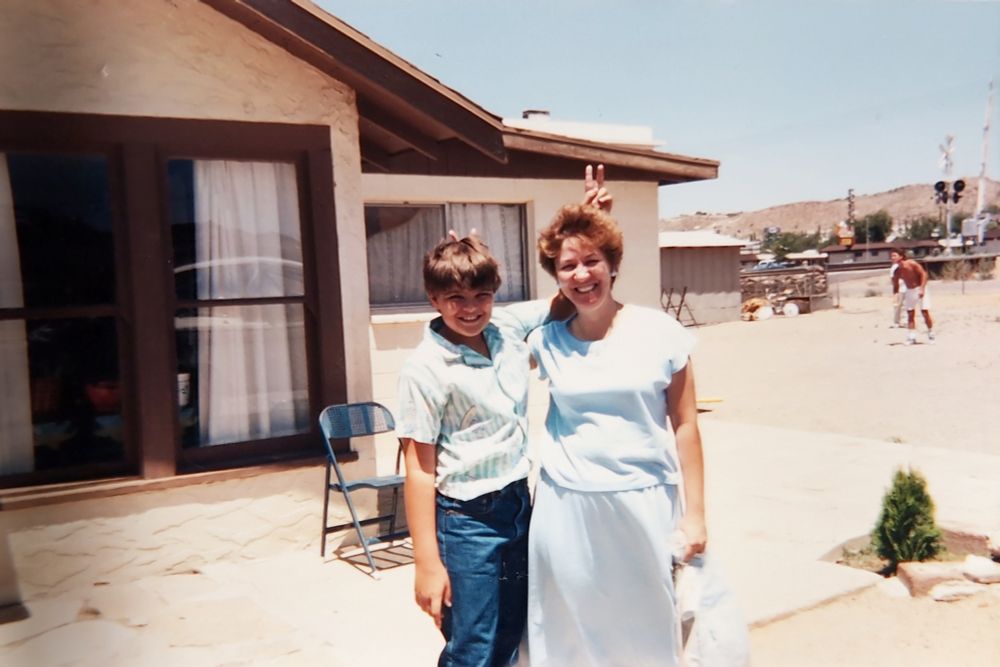 Me and my mom in front of my Abuelos house throwing rabbit ears.