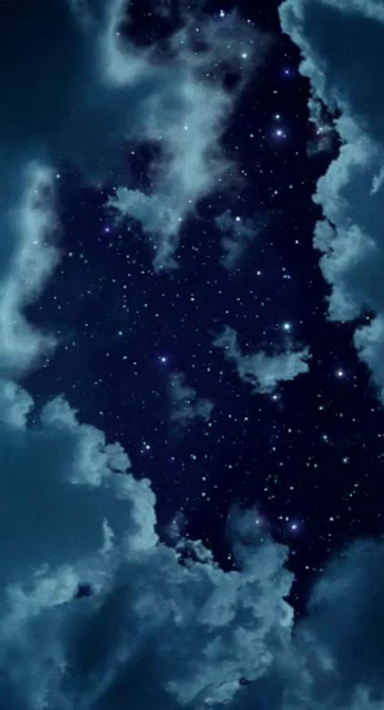 a night sky with lots of stars and clouds in it