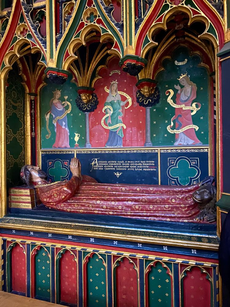 A brightly painted stone effigy over the tomb of John Gower in Southwark Cathedral, London.