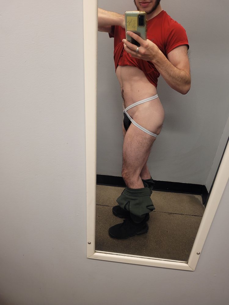 I'm posing in front of the gym change room mirror with my pants down and shirt lifted.