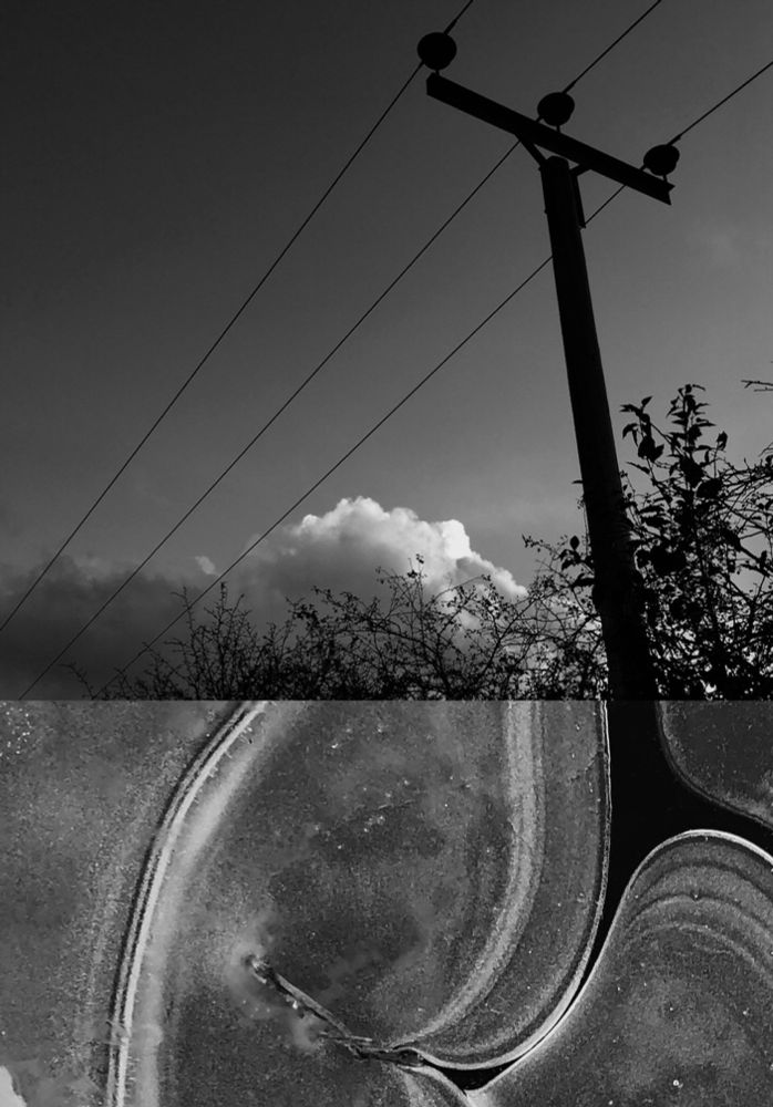 Two B&W photos joined together.
The top photo of a telegraph pole by a hedgerow & low cumulus cloud catching the light in a clear sky.
Below that an abstract detail of the lines & swirls in a frozen puddle, a darker section lines up to the bottom of telegraph pole as if one photo. 