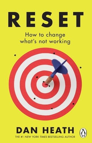 Book cover of Reset: a target with an arroe in the middle, against a fluorescent yellow backdrop