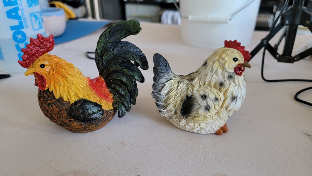 Two chicken figurines, male and female