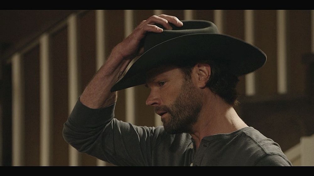 Walker putting on a cowboy hat. 