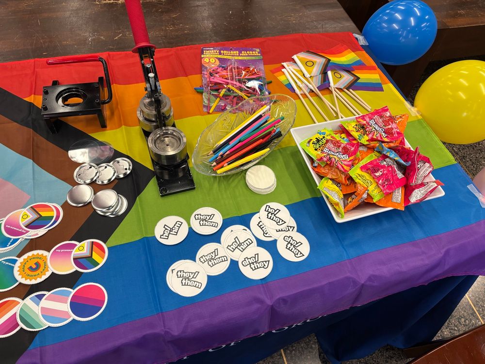 Table for the pride button bar, which has different pronoun buttons, flags and snacks