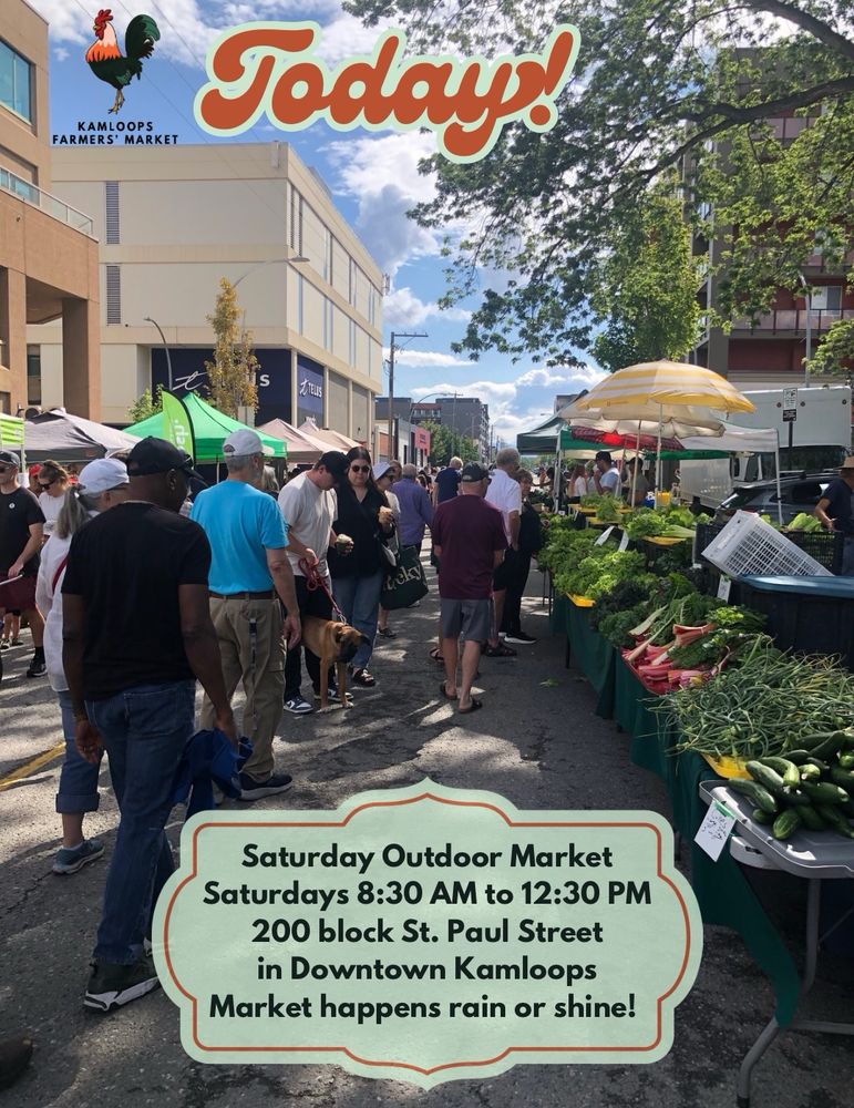 A view of the market on July 19th, looking east from near Silver Springs Organic Farm’s booth near 3rd Avenue & St Paul Street, on a sunny day with dappled shade from the trees. Text on image says, “Saturday Outdoor Market: Saturdays 8:30 AM to 12:30 PM, 200 block St. Paul Street in Downtown Kamloops. Market happens rain or shine!” and “Today”. The KFM rooster logo is in the upper left corner. 