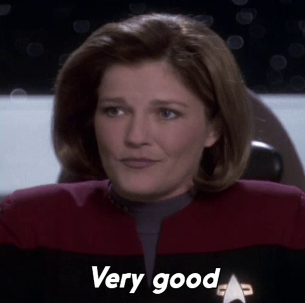 a woman in a star trek uniform has the words very good written on her face