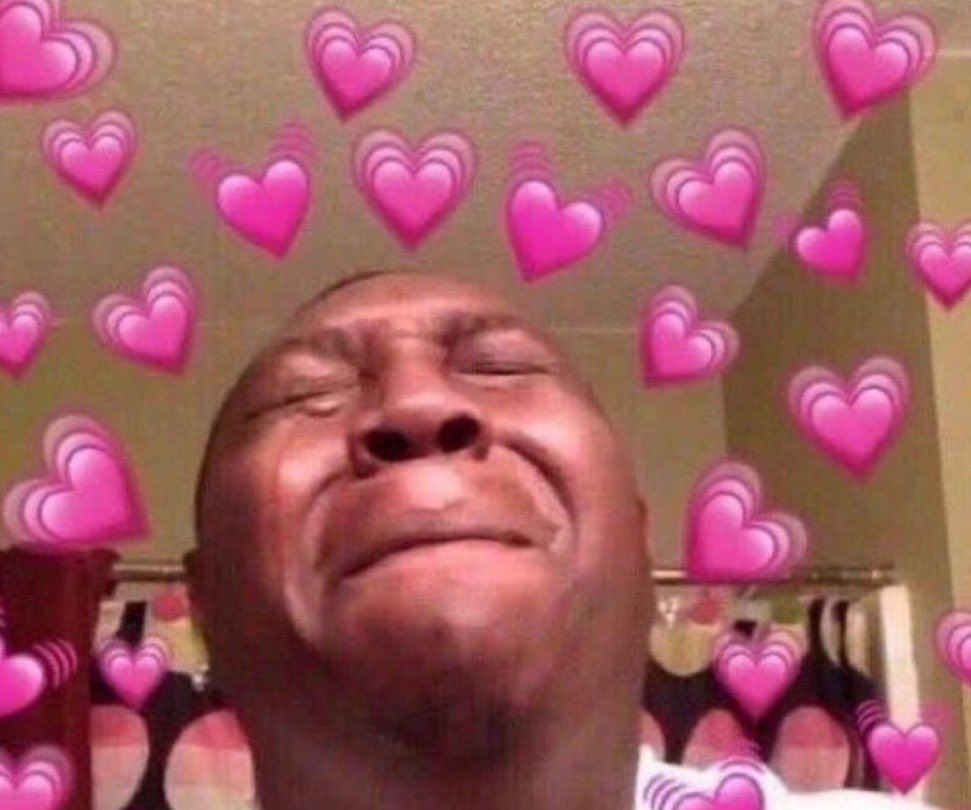 Man crying, surrounded by hearts.