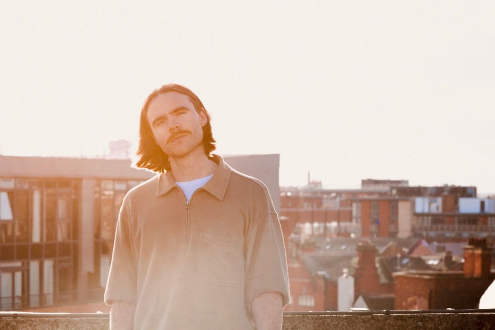 Drew Friel photo in Mount Pleasant car park. The shot is saturated by the sun and there is a scenic backdrop of Liverpool city centre with Drew Friel in the foreground
