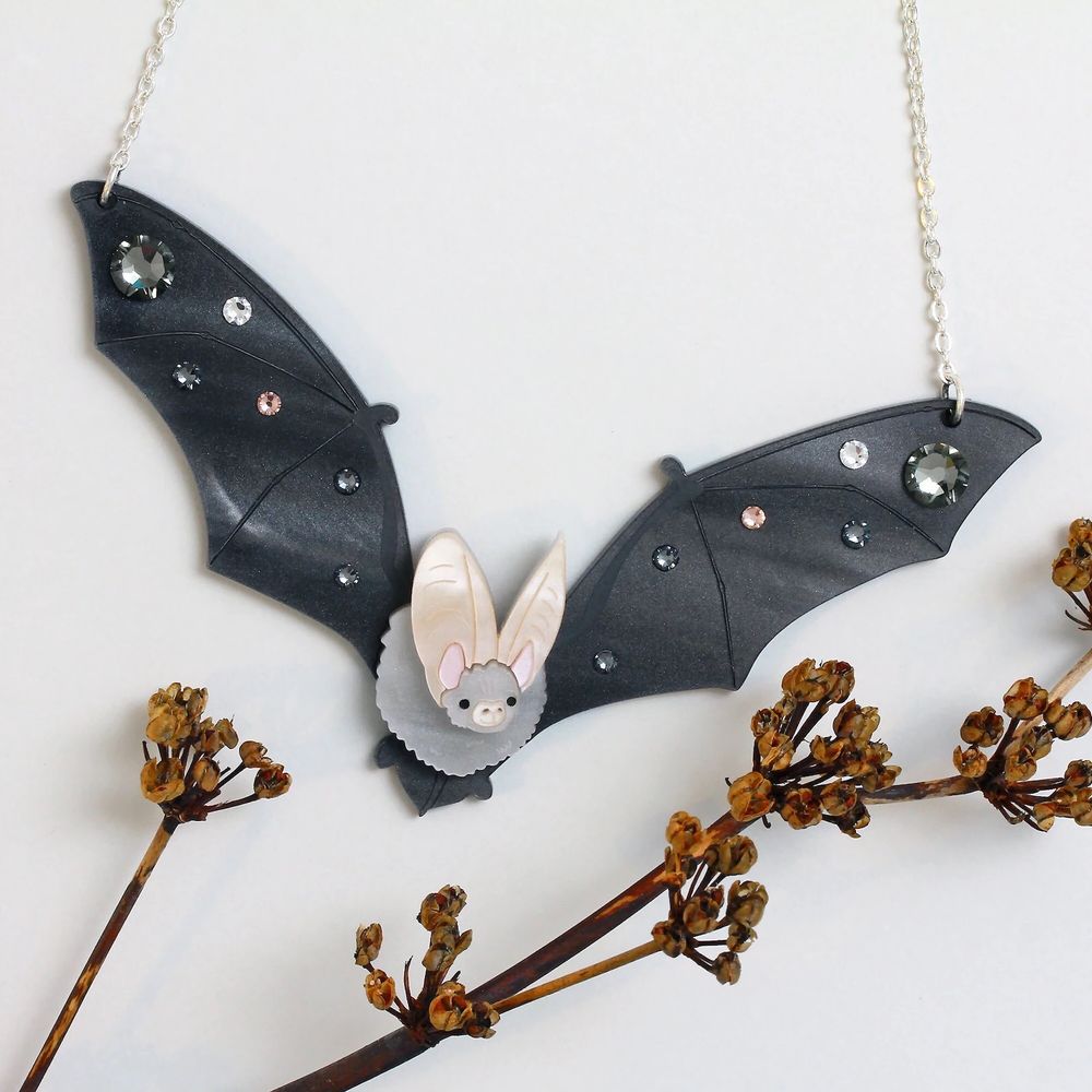 photo of an etsy product: a laser-cut-assembled long eared bat in flight, wings bejeweled