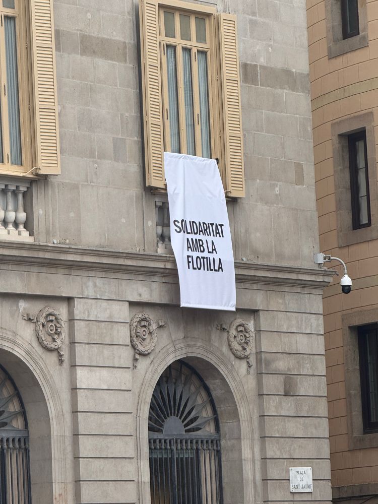 banner on public building reading “solidarity with the flotilla”