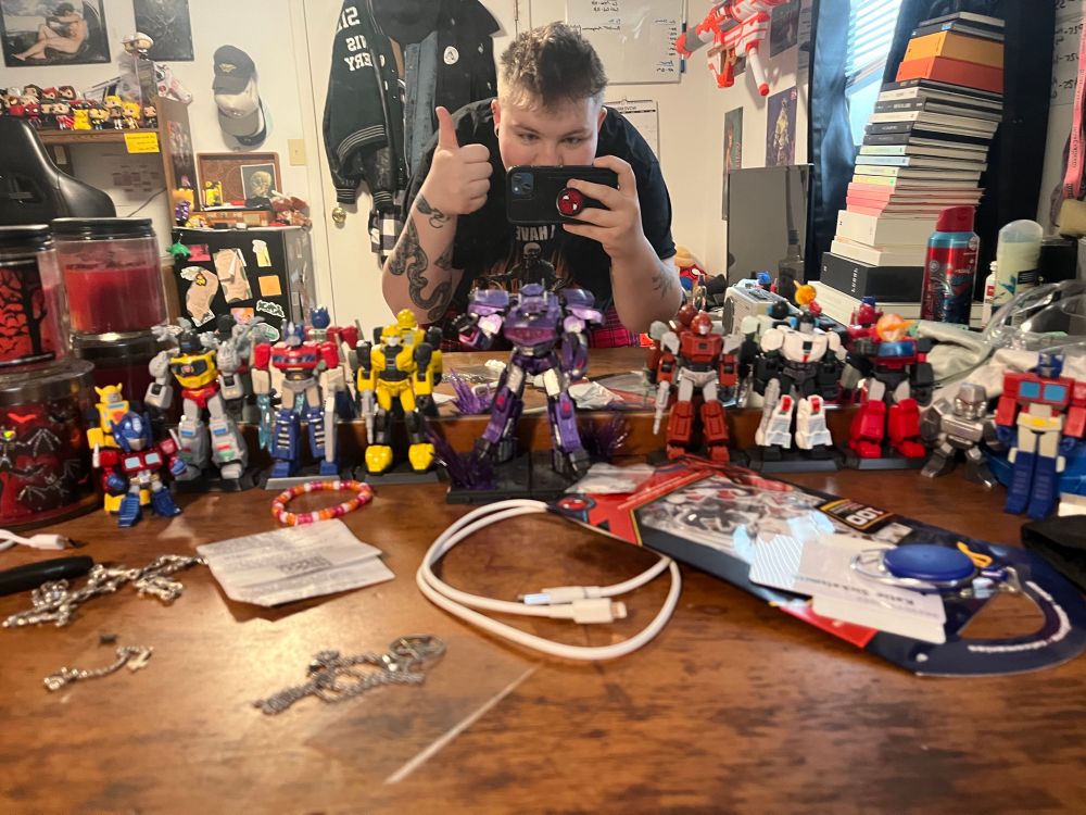 a line of transformers in front of my mirror (also room + face reveal?? terrifying)